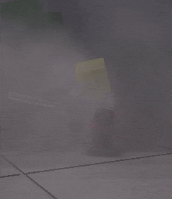 a yellow block with a smiley face is standing in a dark room