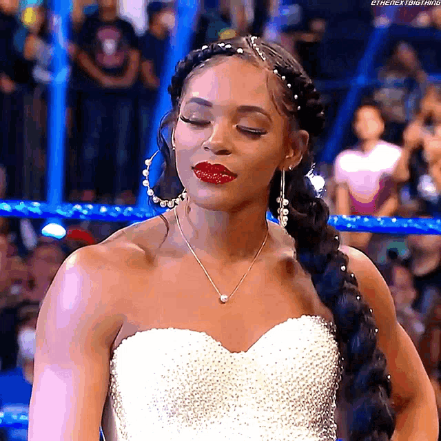 a woman in a wedding dress is standing in a boxing ring