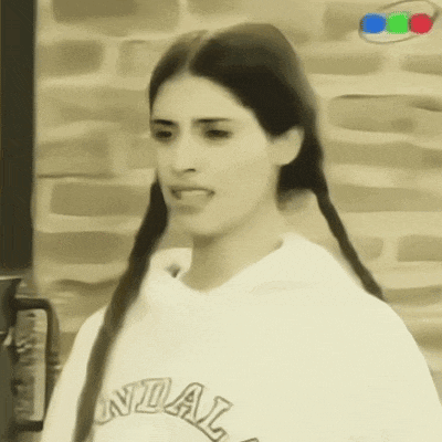a woman is wearing a sweatshirt that says universidad
