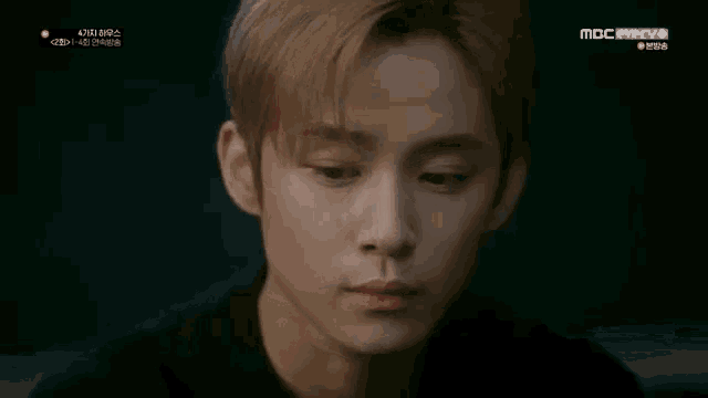 a close up of a man 's face with a mbc watermark on the bottom right