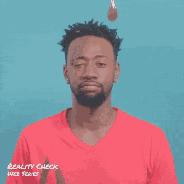 a man in a red shirt has chocolate dripping on his face and the words reality check web series are below him