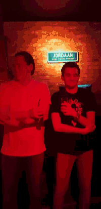 two men standing in front of a jordaan sign