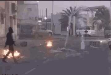 a man is running away from a smoke bomb