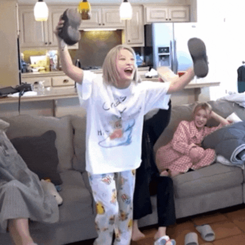 a woman wearing a shirt that says crazy on it holds up her shoes