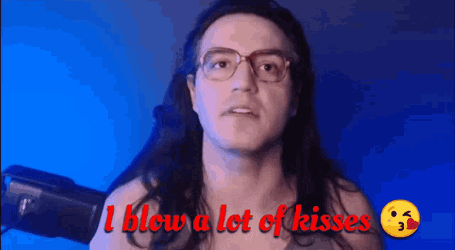 a man with long hair and glasses is saying i blow a lot of kisses