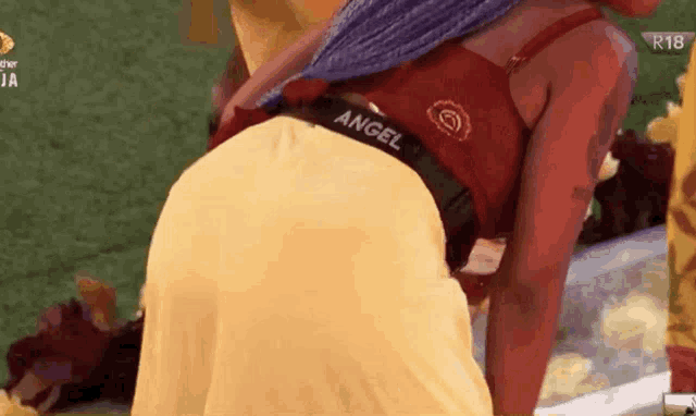 a woman wearing a red top with the word angel on the back