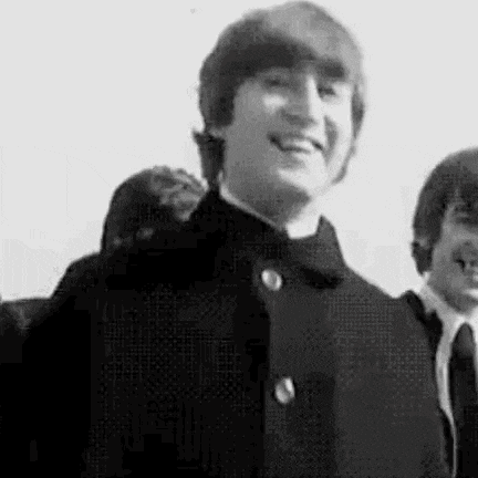 a black and white photo of john lennon and ringo starr .