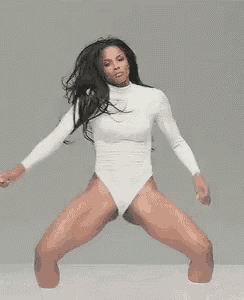 a woman in a white leotard is dancing .