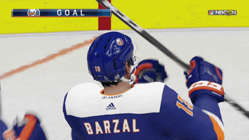 a hockey player with barzal on the back of his jersey celebrates a goal