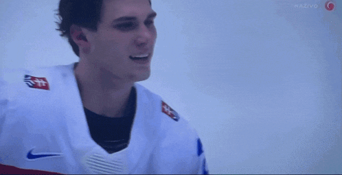 a hockey player wearing a number 10 jersey smiles