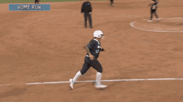 a softball game is underway and a sign says home run