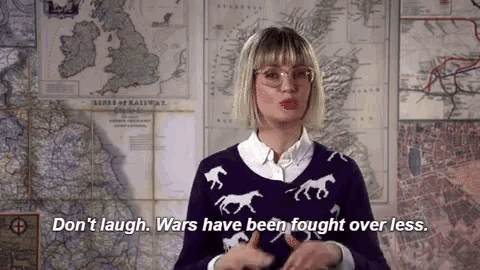a woman in a purple sweater with horses on it says " don 't laugh wars have been fought over less "
