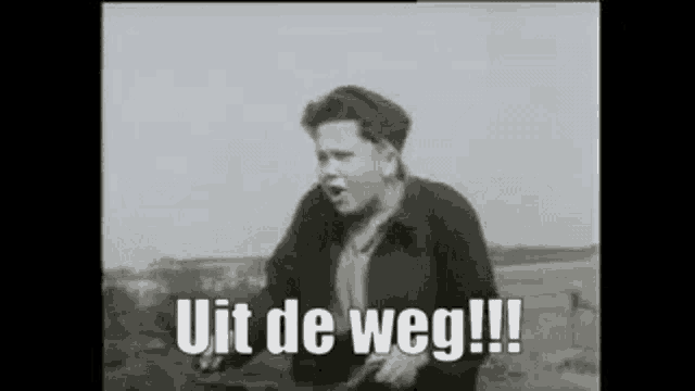 a black and white photo of a boy saying uit de weg !!!