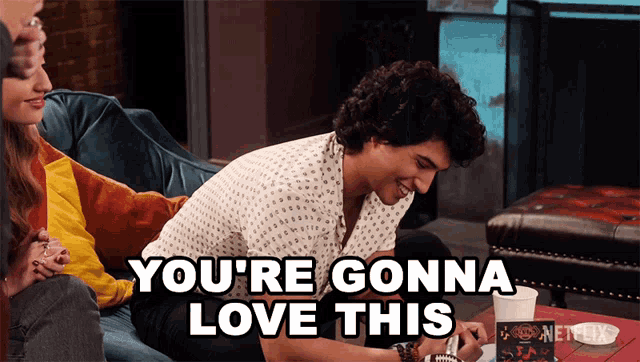 a man sitting on a couch with the words " you 're gonna love this " written above him