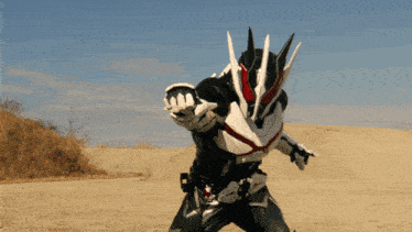 a man in a black and white costume is standing in the dirt