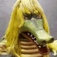 a close up of a person wearing a crocodile costume with yellow hair .