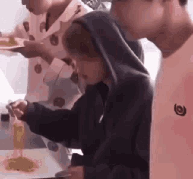 a group of people are eating food at a table .