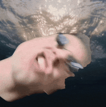 a close up of a person 's face with water coming out of their eyes