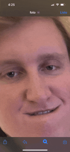 a close up of a man 's face on a phone screen with the time 4:25