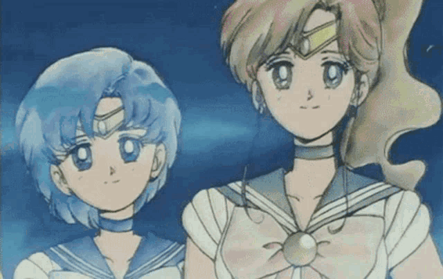 a couple of anime girls standing next to each other .