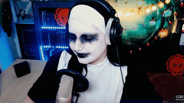 a woman in a nun costume is talking into a microphone with headphones on