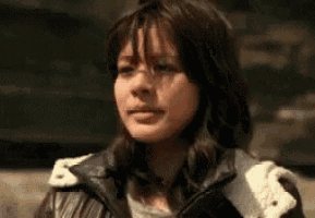 a close up of a woman wearing a leather jacket