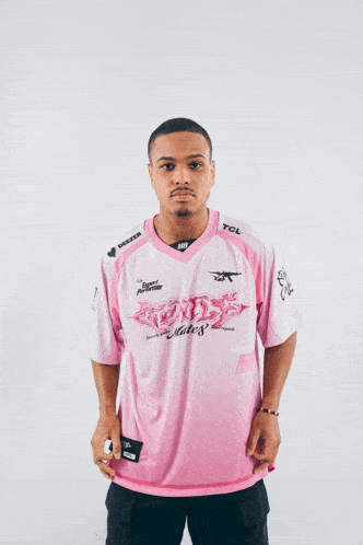 a young man wearing a pink shirt that says nats