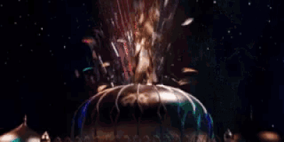 a statue of a man standing on top of a globe with his arms outstretched in front of a crowd .