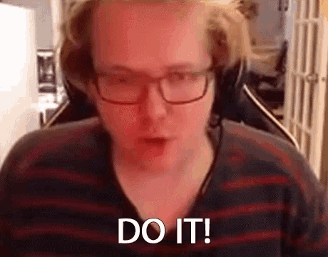 a man wearing glasses and headphones is making a funny face and says `` do it '' .