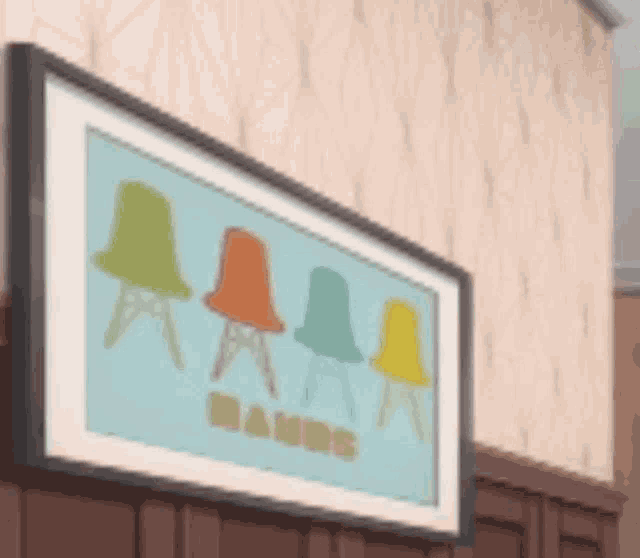 a framed picture of four chairs hanging on a wall