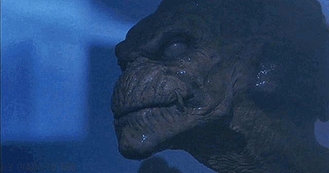 a close up of a monster 's face with a blue background behind it that says ' michael ' on it