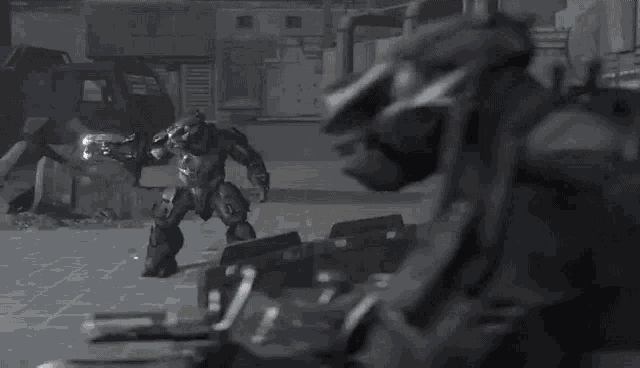 a video game character is holding a gun in a room .
