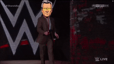 a man in a suit and tie is walking on a stage in front of a w logo .