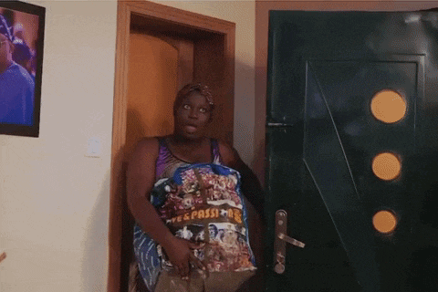 a woman standing in front of a door holding a bag that says ' esperanza ' on it