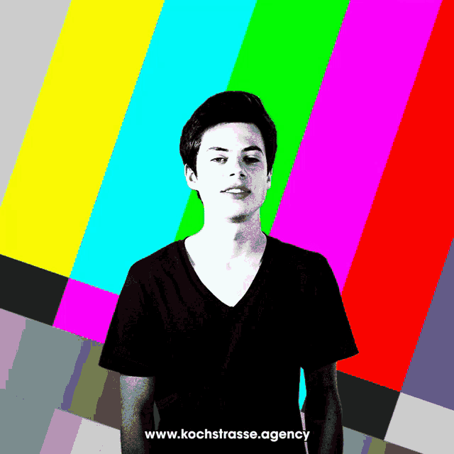 a man stands in front of a colorful background with the website www.kochstrasse.agency written below him