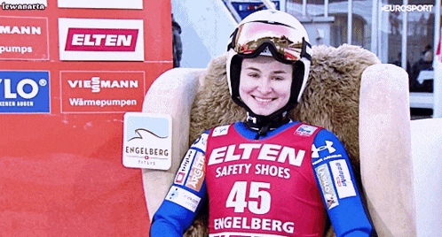 a woman wearing a helmet and goggles is wearing a shirt that says elten safety shoes