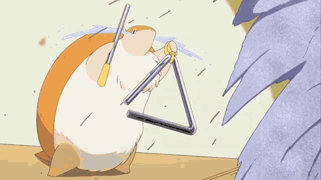 a hamster is holding a triangle in its mouth and crying