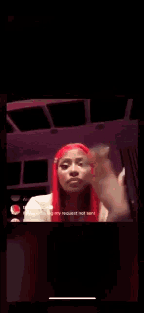 a woman with red hair is covering her face with her hand