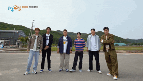 a group of men standing next to each other with a sign in the background that says 1 2 3
