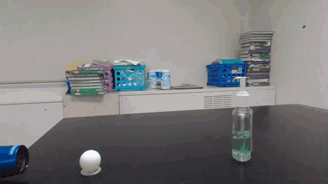 a bottle of hand sanitizer sits on a table in a room
