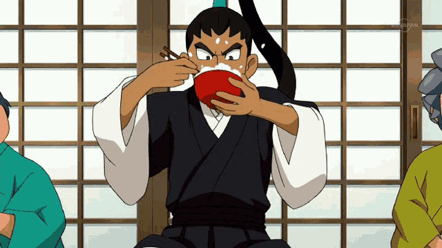 a man in a kimono is eating something with chopsticks from a bowl