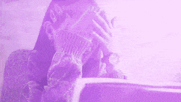 a woman is covering her face with her hands and wearing a watch .