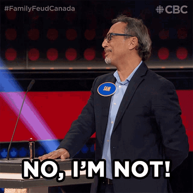 a man in a suit stands at a podium and says " no , i 'm not "