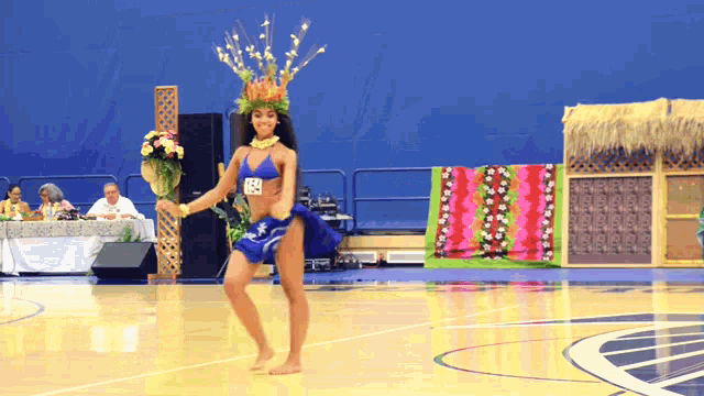 a woman in a bikini is dancing on a basketball court and has the number 88 on her chest