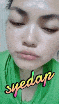 a close up of a woman 's face with the words syedap written on it