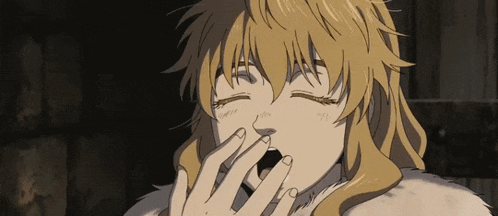 a woman with blonde hair is yawning with her hand over her mouth