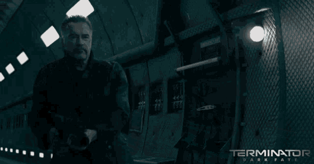 a poster for terminator dark fate shows a man with a flashlight