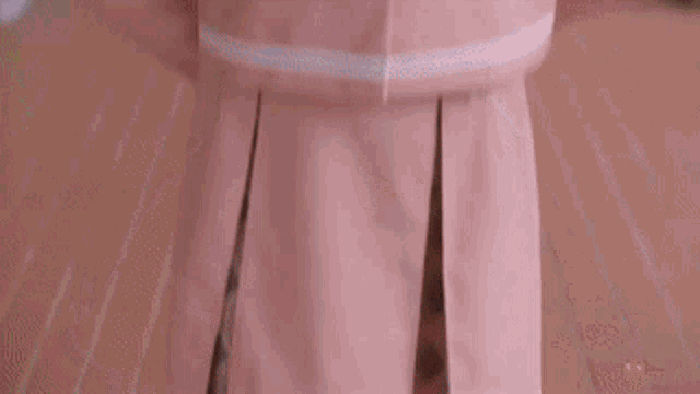 a close up of a person wearing a pink jacket and white bow tie .