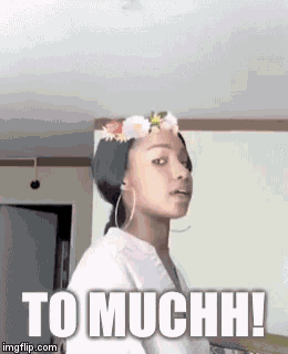 a woman with a flower crown on her head says to muchh !
