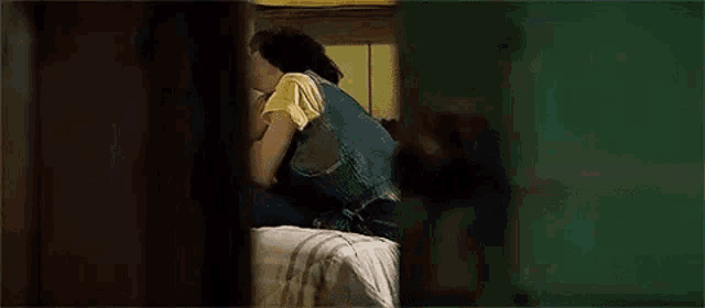 a man and a woman are kissing on a bed .